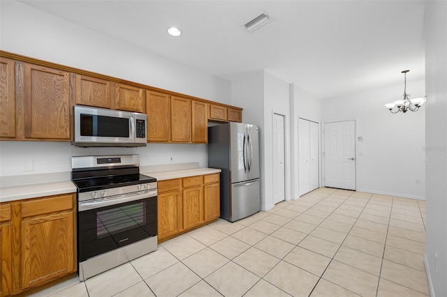 kitchen with a notable chandelier, light tile floors, decorative light fixtures, and appliances with stainless steel finishes