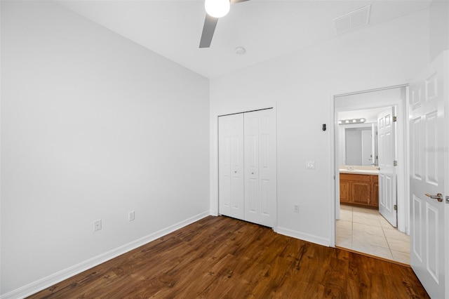 unfurnished bedroom with tile flooring, a closet, and ceiling fan