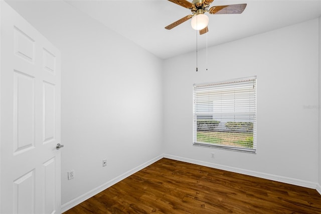 spare room with dark hardwood / wood-style floors and ceiling fan