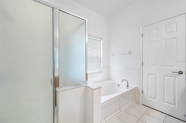 bathroom with tile floors and independent shower and bath