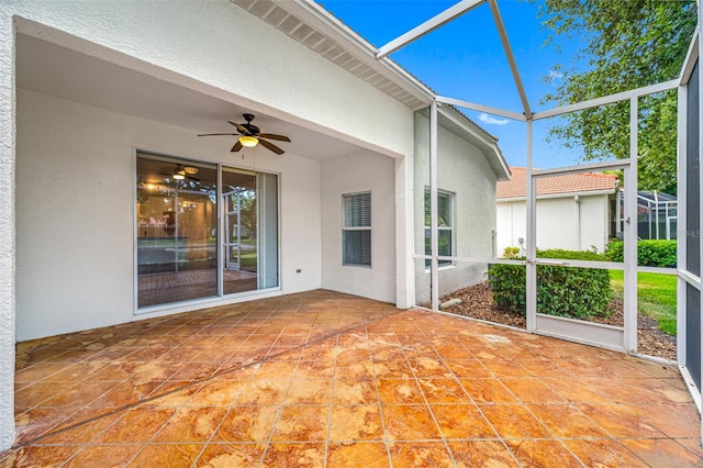 unfurnished sunroom featuring ceiling fan