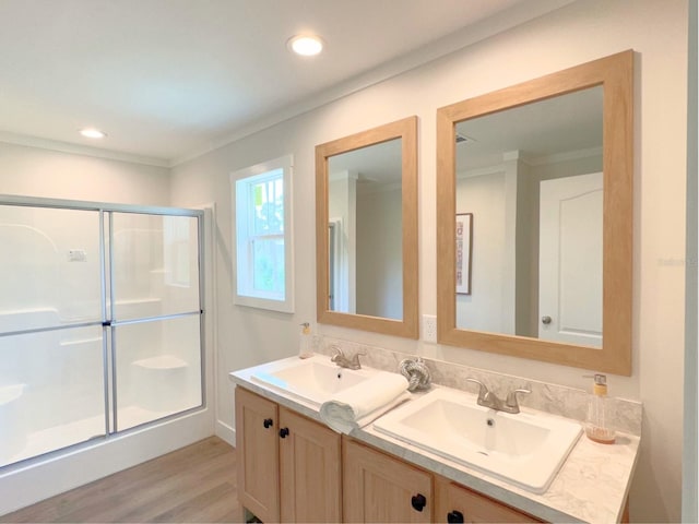 bathroom featuring walk in shower, double sink, wood-type flooring, and large vanity