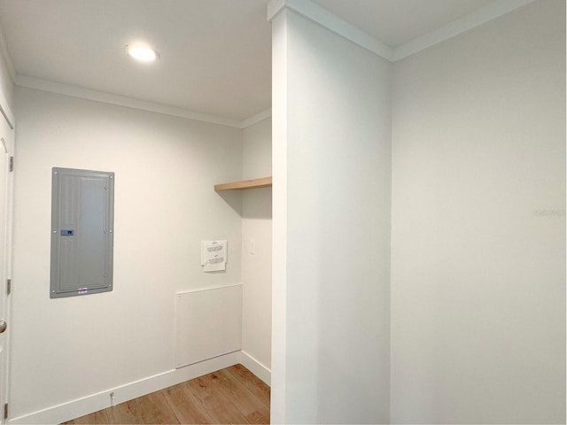 washroom featuring ornamental molding and light hardwood / wood-style floors