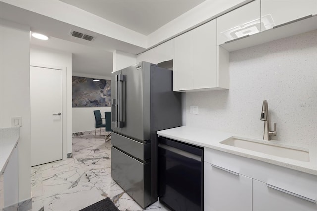 kitchen with white cabinets, high end refrigerator, sink, dishwasher, and light tile floors