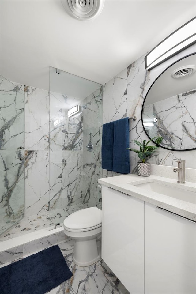 bathroom with tile walls, toilet, tile floors, a shower with door, and vanity