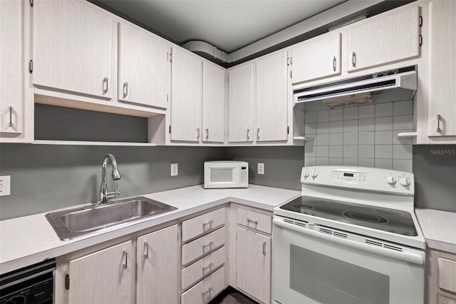 kitchen featuring white appliances, sink, range hood, and tasteful backsplash