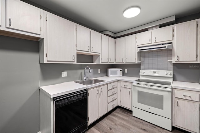 kitchen with light wood-type flooring, white appliances, exhaust hood, backsplash, and sink