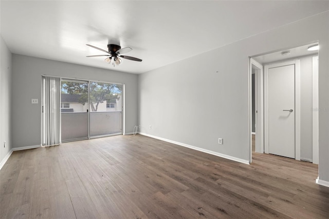 empty room featuring ceiling fan and hardwood / wood-style flooring