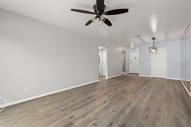 unfurnished living room with ceiling fan and hardwood / wood-style floors