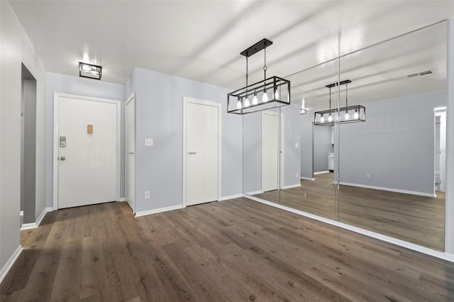 unfurnished dining area featuring dark hardwood / wood-style flooring