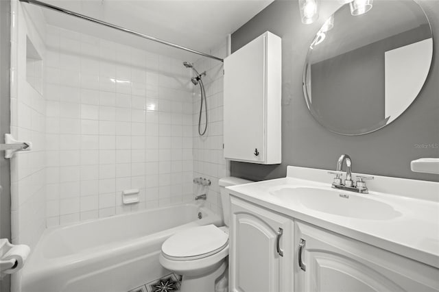 full bathroom featuring tiled shower / bath, oversized vanity, and toilet