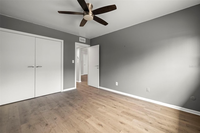 unfurnished bedroom featuring a closet, wood-type flooring, and ceiling fan