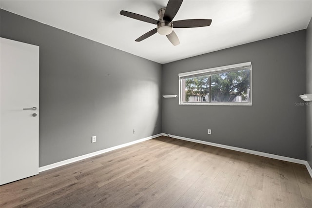 spare room with ceiling fan and hardwood / wood-style flooring