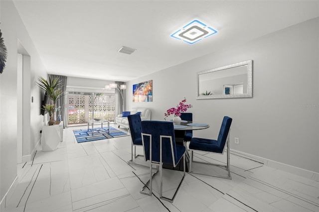 tiled dining area featuring a chandelier