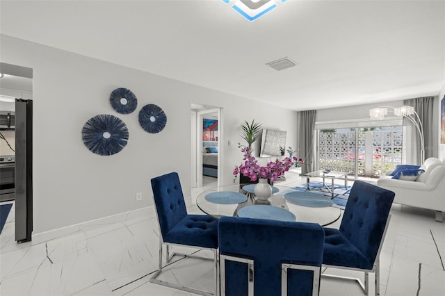 dining room with an inviting chandelier and light tile floors