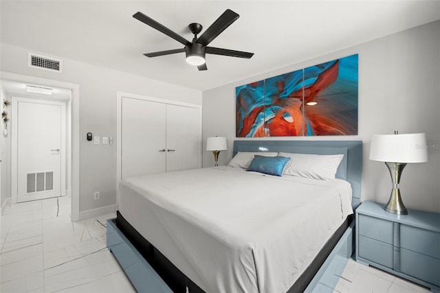 tiled bedroom featuring ceiling fan and a closet