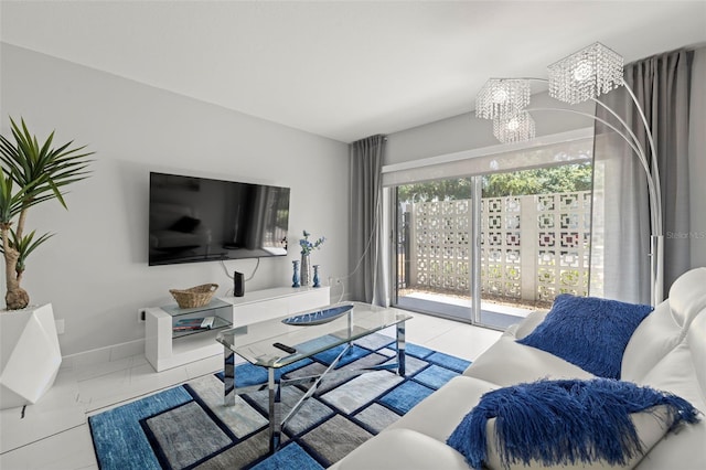 living room with tile floors and a notable chandelier