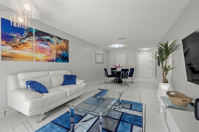 living room with a chandelier and light tile floors