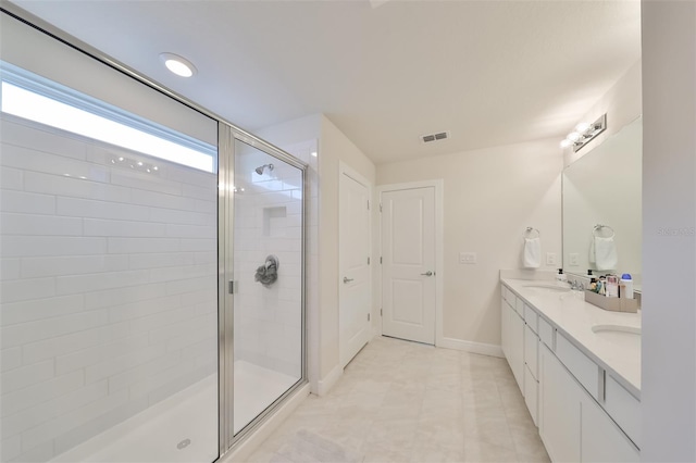 bathroom with dual bowl vanity, tile flooring, and a shower with door