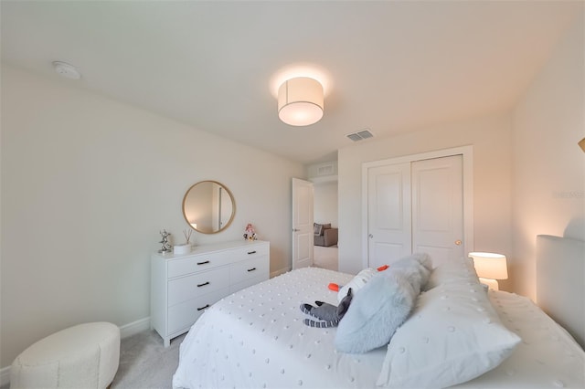 bedroom with a closet and light colored carpet