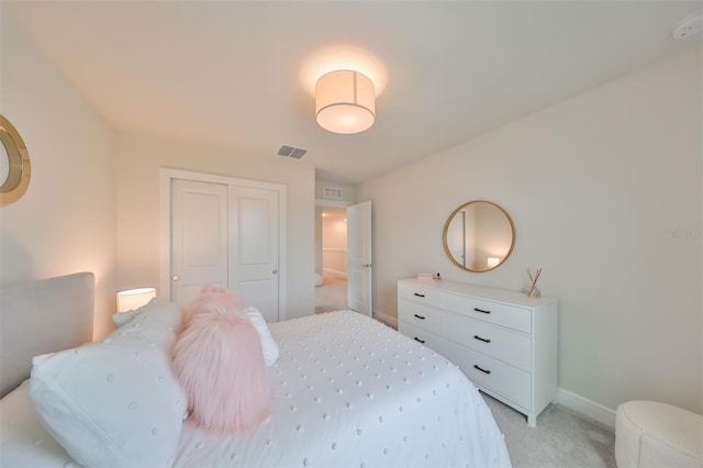 bedroom featuring light carpet and a closet