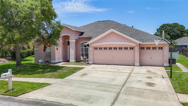 view of front of house with a front yard and a garage