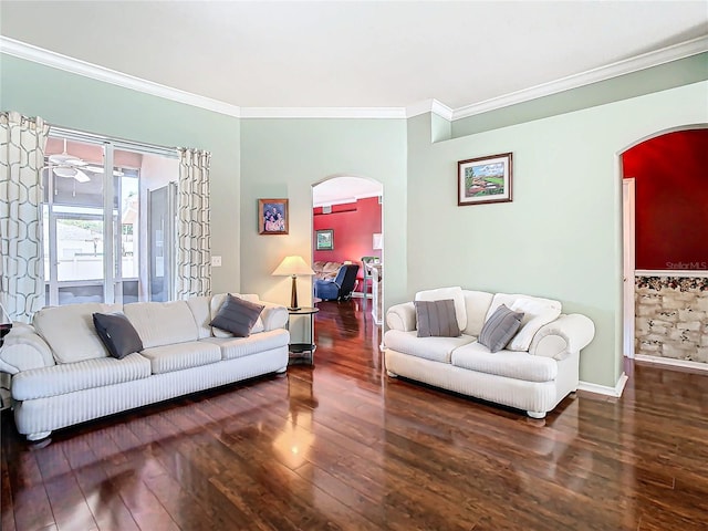 living room featuring ornamental molding, ceiling fan, and dark wood-type flooring