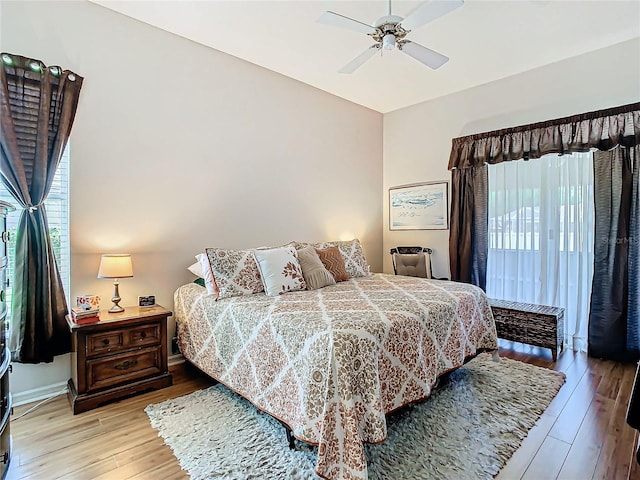 bedroom with ceiling fan and light hardwood / wood-style floors