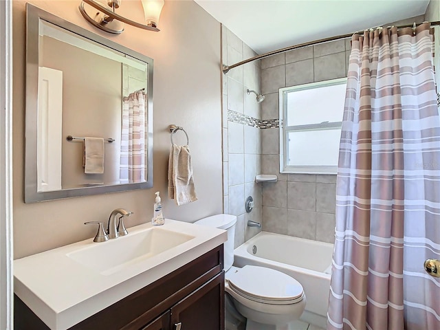 full bathroom featuring shower / bath combo with shower curtain, vanity, and toilet