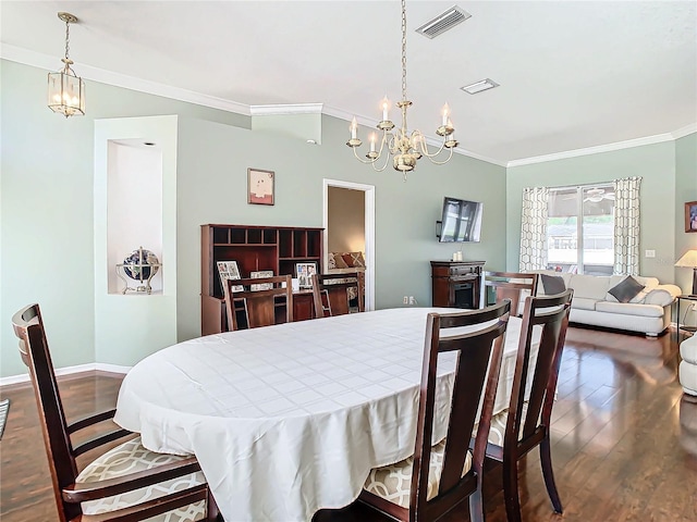 dining space featuring a chandelier, dark hardwood / wood-style floors, and ornamental molding