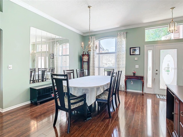 dining room featuring ornamental molding, plenty of natural light, and dark wood-type flooring