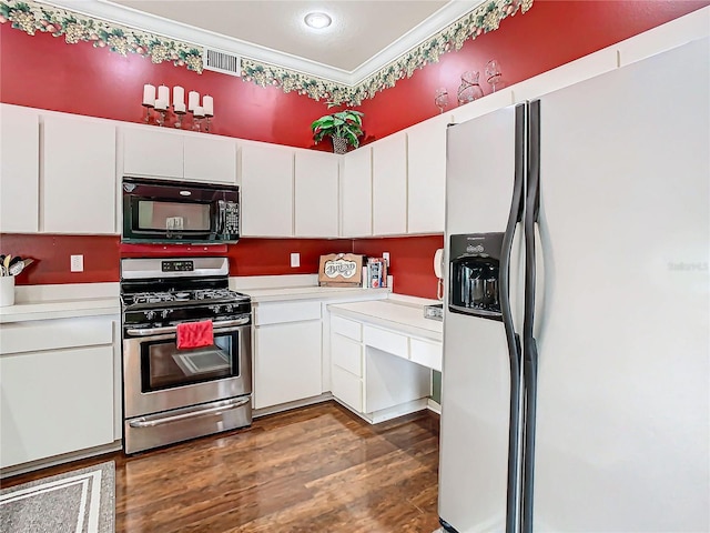 kitchen featuring white cabinets, gas range, white fridge with ice dispenser, ornamental molding, and dark hardwood / wood-style flooring