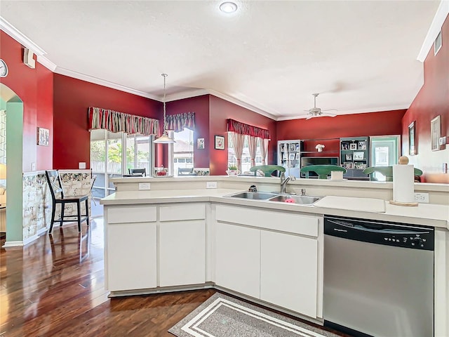 kitchen featuring dishwasher, sink, dark hardwood / wood-style flooring, kitchen peninsula, and white cabinets