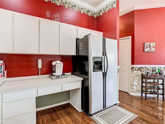 kitchen with stainless steel fridge, dark hardwood / wood-style flooring, white cabinets, and ornamental molding