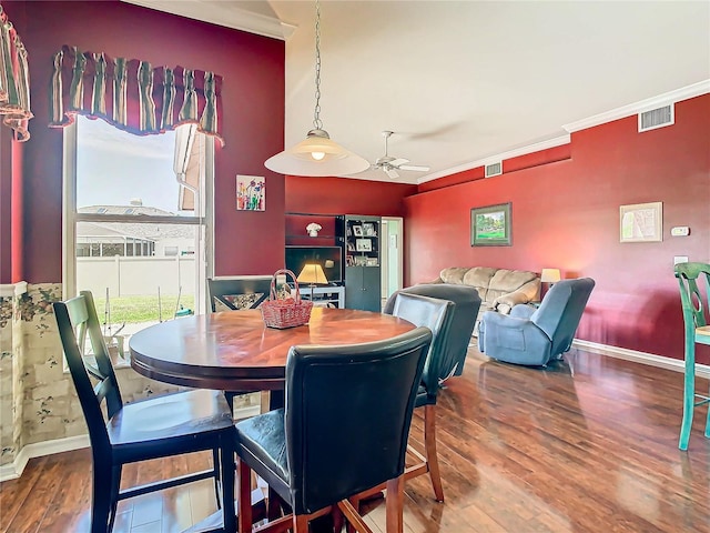 dining area featuring hardwood / wood-style flooring, ceiling fan, and ornamental molding