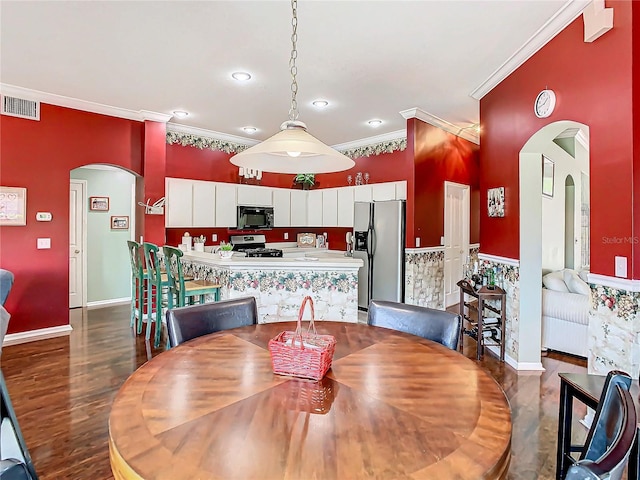 dining room featuring crown molding and dark wood-type flooring