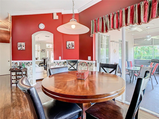 dining area featuring crown molding, ceiling fan, and hardwood / wood-style flooring