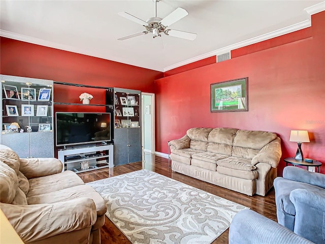 living room featuring ceiling fan, crown molding, and dark wood-type flooring