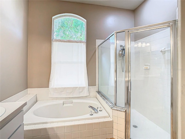 bathroom featuring vanity and independent shower and bath