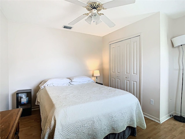 bedroom featuring hardwood / wood-style flooring, a closet, and ceiling fan