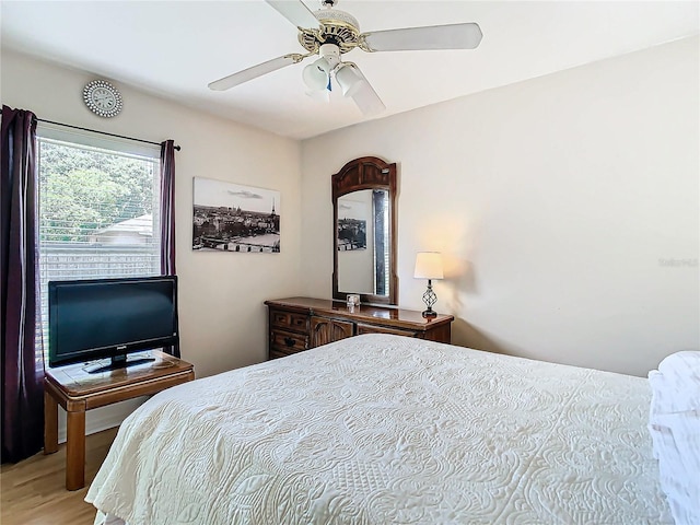 bedroom with hardwood / wood-style floors and ceiling fan