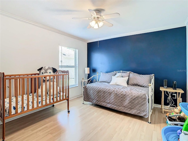 bedroom with ceiling fan, hardwood / wood-style floors, and crown molding