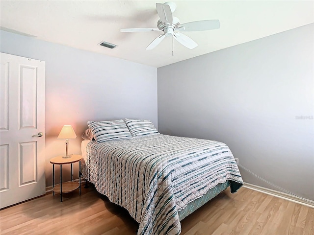 bedroom with hardwood / wood-style floors and ceiling fan