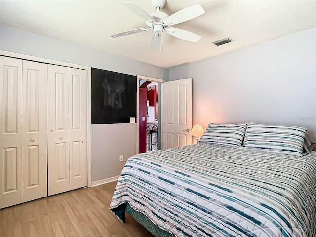 bedroom with a closet, light hardwood / wood-style flooring, and ceiling fan