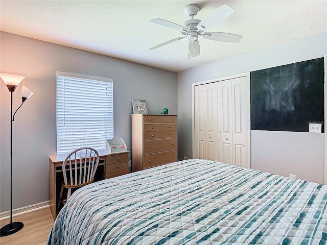 bedroom with light hardwood / wood-style floors, a closet, and ceiling fan