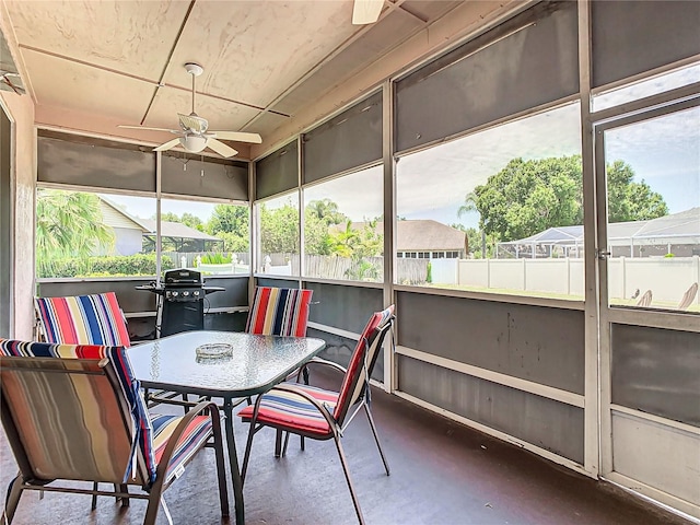 sunroom featuring ceiling fan