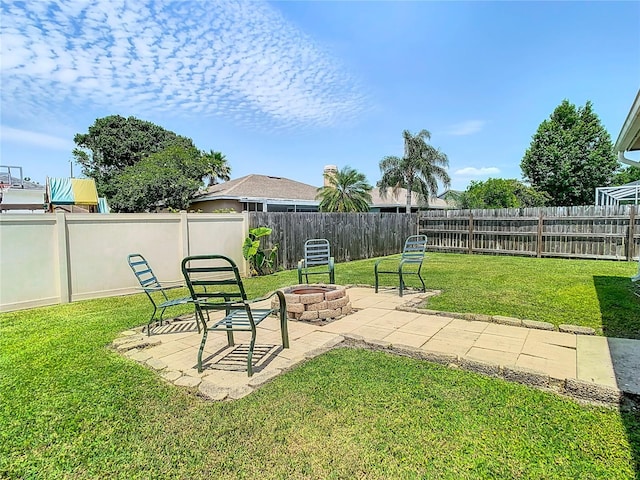 view of yard featuring a fire pit and a patio