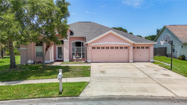 view of front facade with a garage and a front lawn