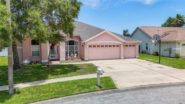 ranch-style house featuring a garage and a front lawn