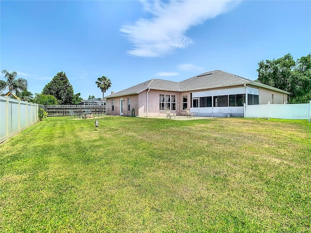 rear view of house with a yard